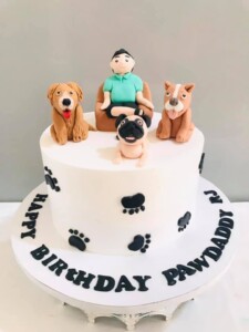 man sitting on a couch with dogs around